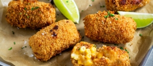 Macaroni Cheese Croquettes on a baking tray with chipotle mayonnaise for dipping.